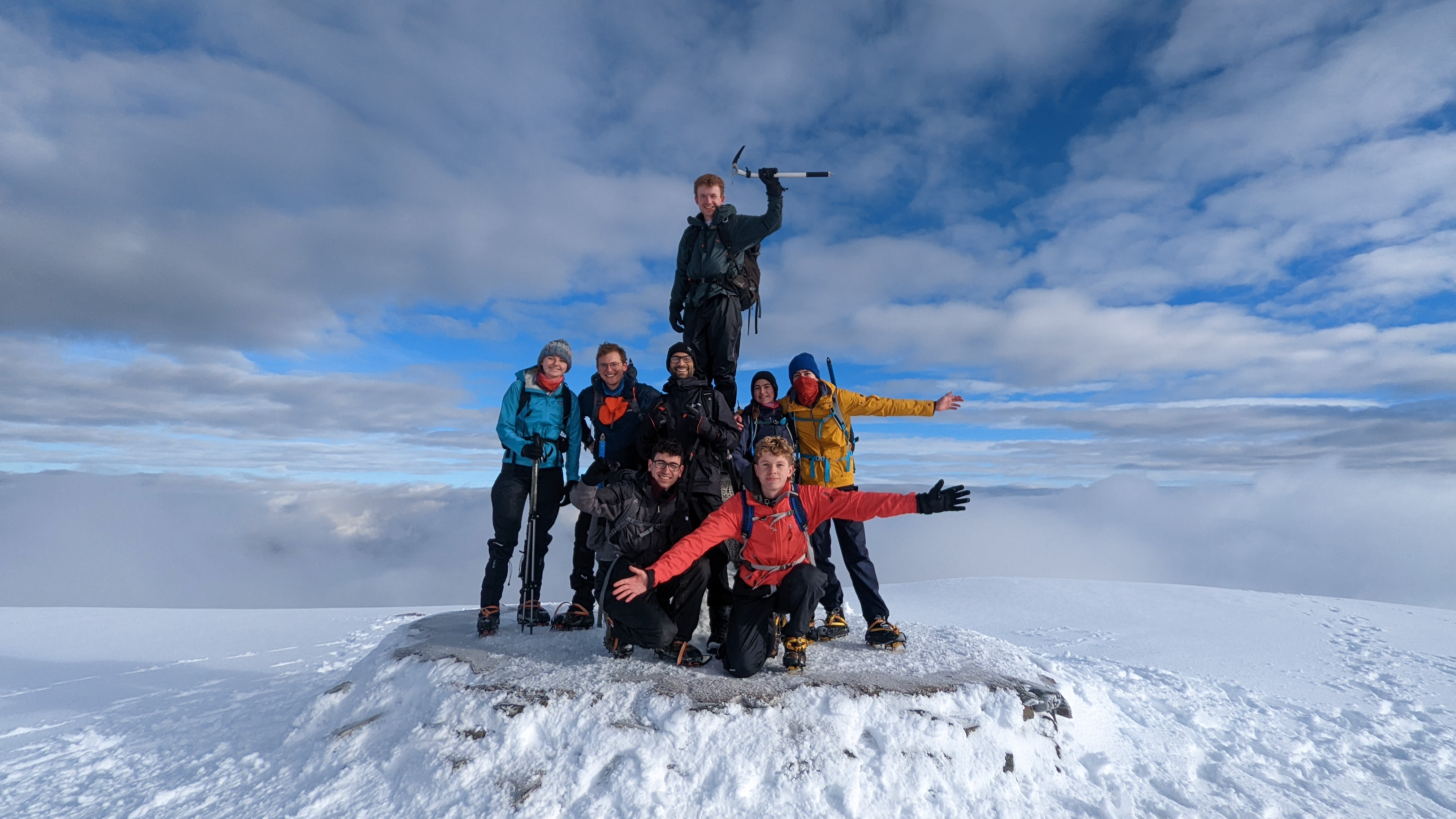 Sam at the peak of Ben Nevis, on a journey to summit the three highest mountains in Scotland, Wales, and England in 24 hours.